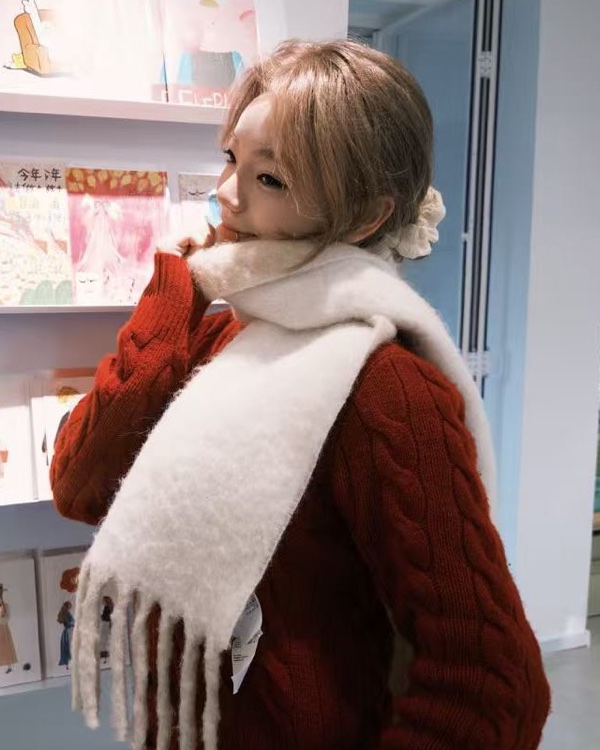 Estelle in a red sweater and white scarf